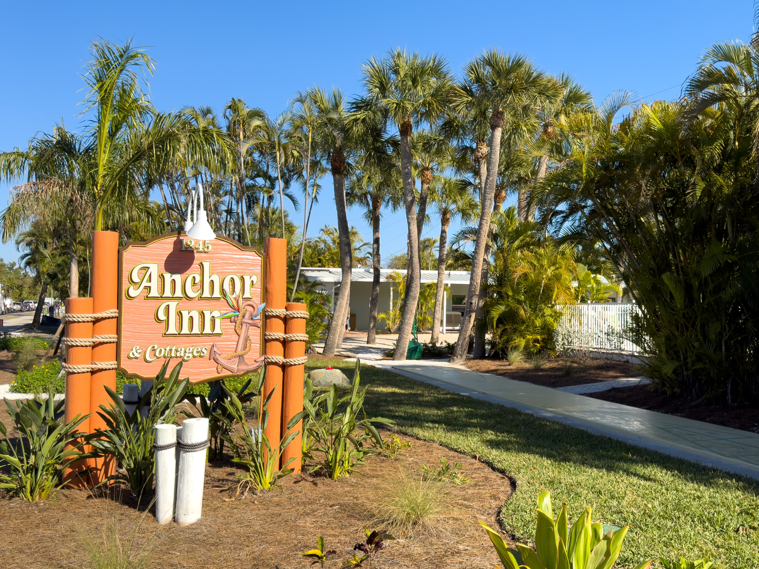 Newly renovated Anchor Inn & Cottages on Sanibel Island with tropical palms and entrance walkway.