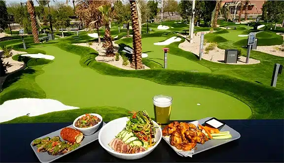 Food and drinks at Island Cow overlooking tropical mini golf course on Sanibel Island